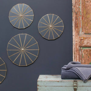 Wooden sustainable furniture and round wall decor on dark blue wall