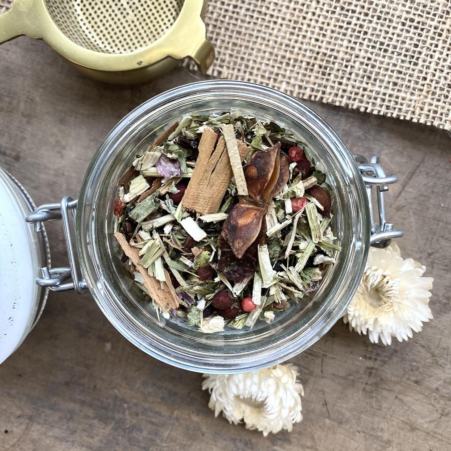 Loose leaf tea in glass jar with metal strainer and flowers from sustainable shop in Henley-on-Thames